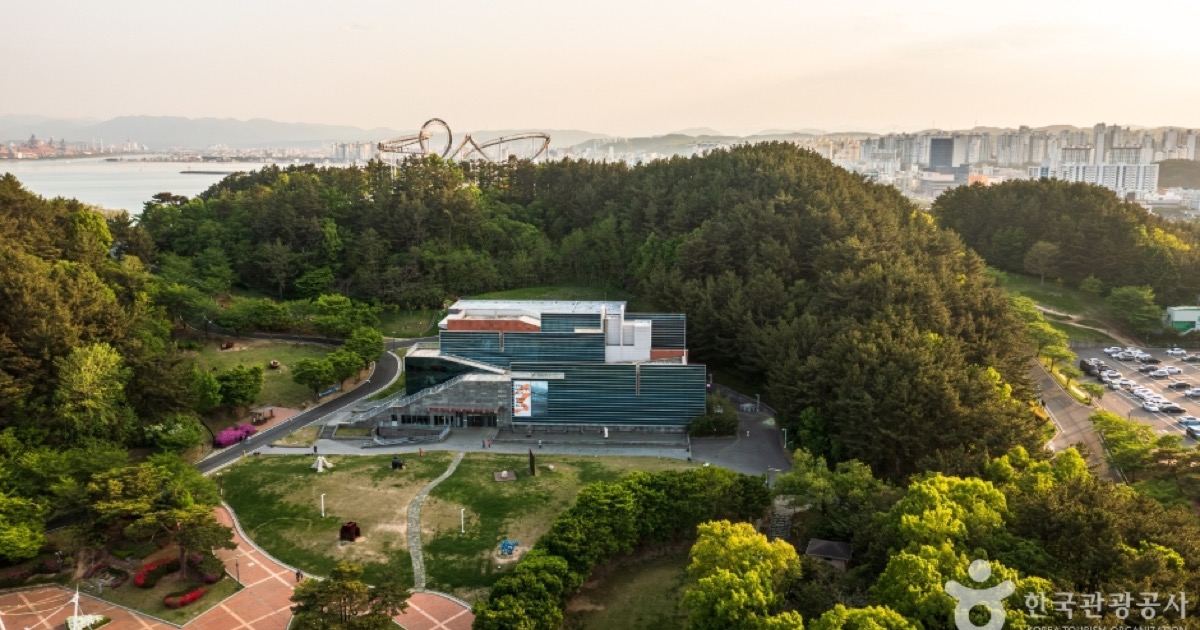 Hwanho Park at sunset with Pohang Space Walk rising above the trees